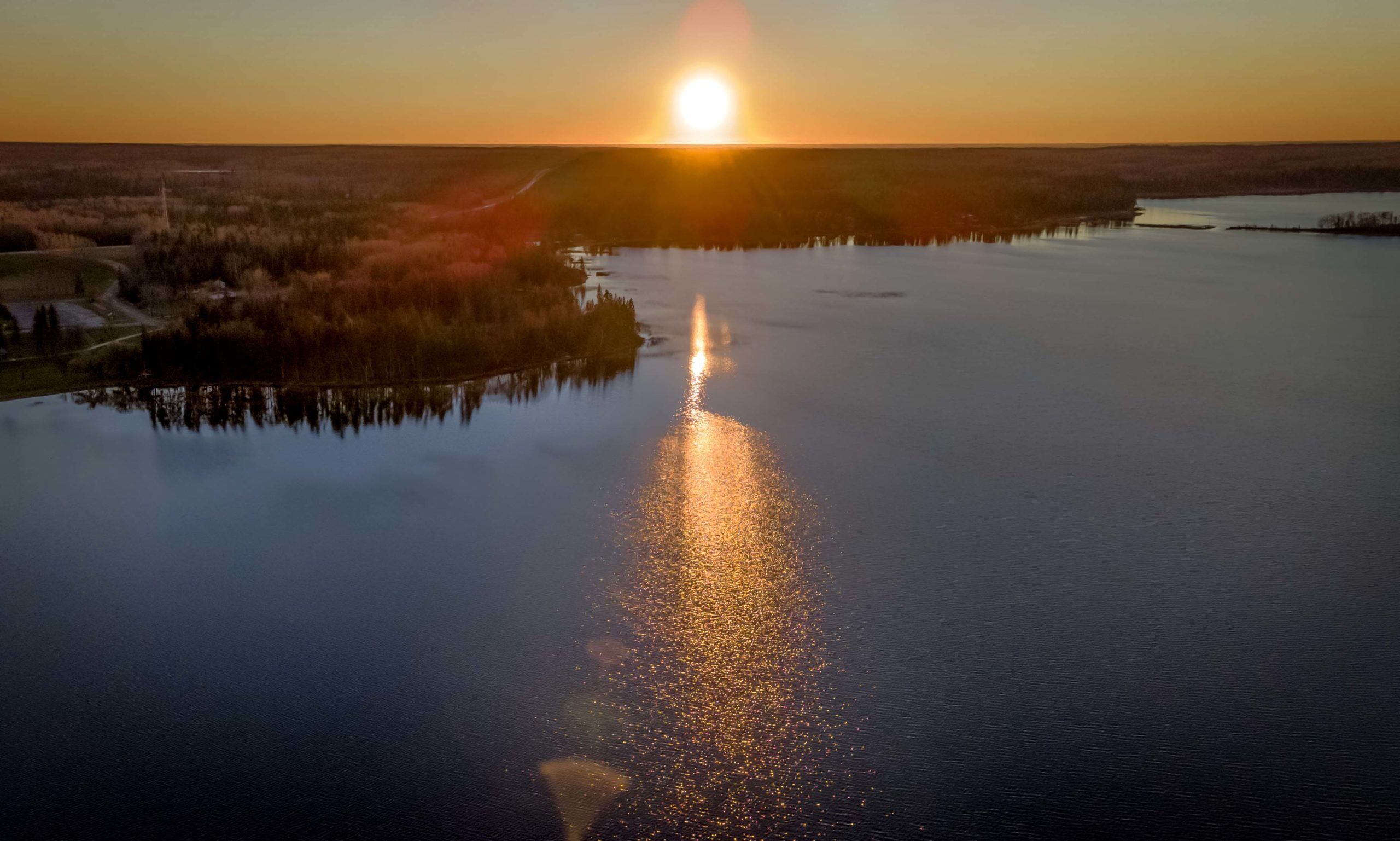 Sunset over a remote lake and fall forest in Canada